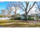 Well-maintained home with a spacious yard, mature trees, and a charming front porch at 577 Rivers Rd, Fayetteville, GA 30214