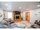 Inviting living room with a stone fireplace, hardwood floors, and a comfortable seating area at 577 Rivers Rd, Fayetteville, GA 30214