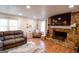 Inviting living room with a stone fireplace, hardwood floors, and a comfortable seating area at 577 Rivers Rd, Fayetteville, GA 30214