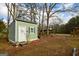Backyard storage shed with white door and shutters at 577 Rivers Rd, Fayetteville, GA 30214