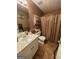 Cozy bathroom featuring a white vanity, decorative tile backsplash, and a shower with a patterned curtain at 75 Trelawney Keep, Covington, GA 30016