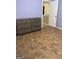 This bedroom offers tile flooring and soft lavender walls for a bright yet warm feel at 75 Trelawney Keep, Covington, GA 30016