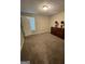 This bedroom features neutral walls, carpet, and an accenting wooden dresser for a warm feel at 75 Trelawney Keep, Covington, GA 30016
