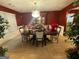 Dining room with a large table, decorative chandelier, and rich red walls at 75 Trelawney Keep, Covington, GA 30016