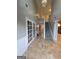 Inviting foyer with staircase, tile flooring, and French doors leading to another room at 75 Trelawney Keep, Covington, GA 30016