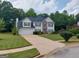 Charming two-story home with a two-car garage, stone accents, manicured lawn, and lovely curb appeal at 75 Trelawney Keep, Covington, GA 30016