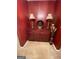 Hallway featuring a cherry colored cabinet and decorations, with plush carpeting at 75 Trelawney Keep, Covington, GA 30016