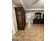 This hallway features tile flooring, dark wood furniture, and ample lighting for a cozy feel at 75 Trelawney Keep, Covington, GA 30016