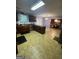 Open kitchen with wooden cabinets, stainless steel dishwasher, and access to dining area at 75 Trelawney Keep, Covington, GA 30016