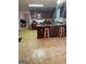 Functional kitchen with wooden cabinets, tile flooring, and breakfast bar seating at 75 Trelawney Keep, Covington, GA 30016