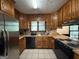 Traditional kitchen with black appliances, wood cabinets, and tile flooring at 5350 Hearn, Ellenwood, GA 30294