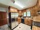 Traditional kitchen with stainless steel refrigerator, wood cabinets, and tile flooring at 5350 Hearn, Ellenwood, GA 30294