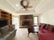 Spacious living room with a stone fireplace, wood built-ins, and neutral carpet at 5350 Hearn, Ellenwood, GA 30294