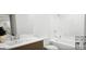 This bathroom features a clean design with modern fixtures, including a toilet, bathtub, and sink at 1246 Trombone Way # 111, Mcdonough, GA 30252
