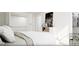 Bright bedroom featuring white walls, a comfortable bed, and a glimpse into a walk-in closet at 1246 Trombone Way # 111, Mcdonough, GA 30252