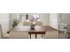 Elegant dining room with a wooden table, seating for six, neutral color palette, and a floorplan overview in corner at 1246 Trombone Way # 111, Mcdonough, GA 30252