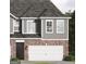 Charming two-story home showcasing a two-car garage and mixed brick and siding facade at 2020 Piccolo Ct # 229, Mcdonough, GA 30252