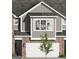 Charming townhome featuring brick accents and a two-car garage, blending modern design with classic materials at 2024 Piccolo Ct # 228, Mcdonough, GA 30252