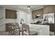 Modern kitchen with sleek countertops, stainless steel appliances, and a breakfast bar with seating at 2024 Piccolo Ct # 228, Mcdonough, GA 30252