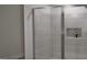 Modern shower featuring marble-look tile and a frameless glass door at 2024 Piccolo Ct # 228, Mcdonough, GA 30252