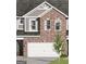 Charming two-story townhome showcasing brick and gray siding, complemented by an attached two-car garage at 2036 Piccolo Ct # 225, Mcdonough, GA 30252
