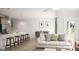 Open-concept living space featuring wood floors, modern decor, and a view to the kitchen and dining areas at 2036 Piccolo Ct # 225, Mcdonough, GA 30252