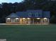 Charming home at night with a beautiful lawn and welcoming exterior lighting at 376 Turner Cir, Mcdonough, GA 30252