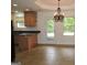 Open kitchen area with a breakfast bar, granite countertops and a chandelier at 376 Turner Cir, Mcdonough, GA 30252