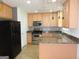 Well-equipped kitchen with stainless steel appliances, light wood cabinets, and granite countertops at 376 Turner Cir, Mcdonough, GA 30252