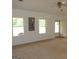 Bright living room with neutral carpet, an exit to a patio, and plenty of natural light at 376 Turner Cir, Mcdonough, GA 30252