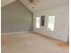 Spacious living room with high ceilings, three bright windows, and neutral carpet at 376 Turner Cir, Mcdonough, GA 30252