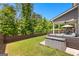 Private fenced backyard with lush green lawn, patio seating, and room for outdoor activities at 510 Cunninghame Ct, Peachtree City, GA 30269