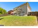 Large backyard with grass, seating area, and privacy fence that is perfect for outdoor enjoyment at 510 Cunninghame Ct, Peachtree City, GA 30269
