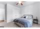 Neutral bedroom with a bed, ceiling fan and two closets, featuring neutral paint and carpet at 510 Cunninghame Ct, Peachtree City, GA 30269