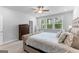 Bedroom featuring a plush bed, dresser, and window with natural light, creating a cozy and inviting space at 510 Cunninghame Ct, Peachtree City, GA 30269