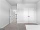 Neutral toned room with carpet that offers doors to the bathroom and bedroom closet at 510 Cunninghame Ct, Peachtree City, GA 30269