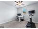 Cozy carpeted bedroom providing a desk, computer, and mounted flat screen, perfect for work or exercise at 510 Cunninghame Ct, Peachtree City, GA 30269