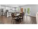 Bright kitchen and dining area with white cabinetry, stainless steel appliances, and an access to outdoor space at 510 Cunninghame Ct, Peachtree City, GA 30269