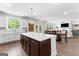 Open kitchen featuring an island, white cabinetry, and a seamless transition to the adjacent dining area at 510 Cunninghame Ct, Peachtree City, GA 30269