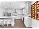 Well-lit kitchen with white cabinets, modern appliances, large island, and custom spice rack feature at 510 Cunninghame Ct, Peachtree City, GA 30269