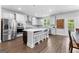 Bright kitchen features stainless appliances, a large island with seating, and sleek white cabinetry at 510 Cunninghame Ct, Peachtree City, GA 30269