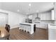 Spacious kitchen with modern white cabinets, stainless appliances, and a large central island with seating at 510 Cunninghame Ct, Peachtree City, GA 30269