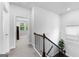 Upstairs landing with hardwood staircase, neutral carpeting, and bright natural light at 510 Cunninghame Ct, Peachtree City, GA 30269