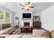 Cozy living room with a fireplace, ceiling fan, and neutral decor, creating a welcoming atmosphere at 510 Cunninghame Ct, Peachtree City, GA 30269
