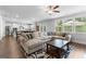 Bright living room featuring a comfortable sectional sofa and large windows for natural light at 510 Cunninghame Ct, Peachtree City, GA 30269