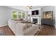 Open-concept living room features a fireplace, large windows, and comfortable seating for relaxation and entertainment at 510 Cunninghame Ct, Peachtree City, GA 30269