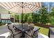 Cozy outdoor patio with an umbrella shaded dining area for gatherings and entertaining in the backyard at 510 Cunninghame Ct, Peachtree City, GA 30269