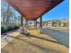 A pergola with benches sits on manicured grass, offering a peaceful spot within the community at 510 Cunninghame Ct, Peachtree City, GA 30269