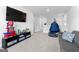 Large recreation room with a sofa, TV, and toys, featuring neutral carpet and paint at 510 Cunninghame Ct, Peachtree City, GA 30269