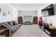 Large recreation room with a sofa, TV, and games, featuring neutral carpet and paint at 510 Cunninghame Ct, Peachtree City, GA 30269